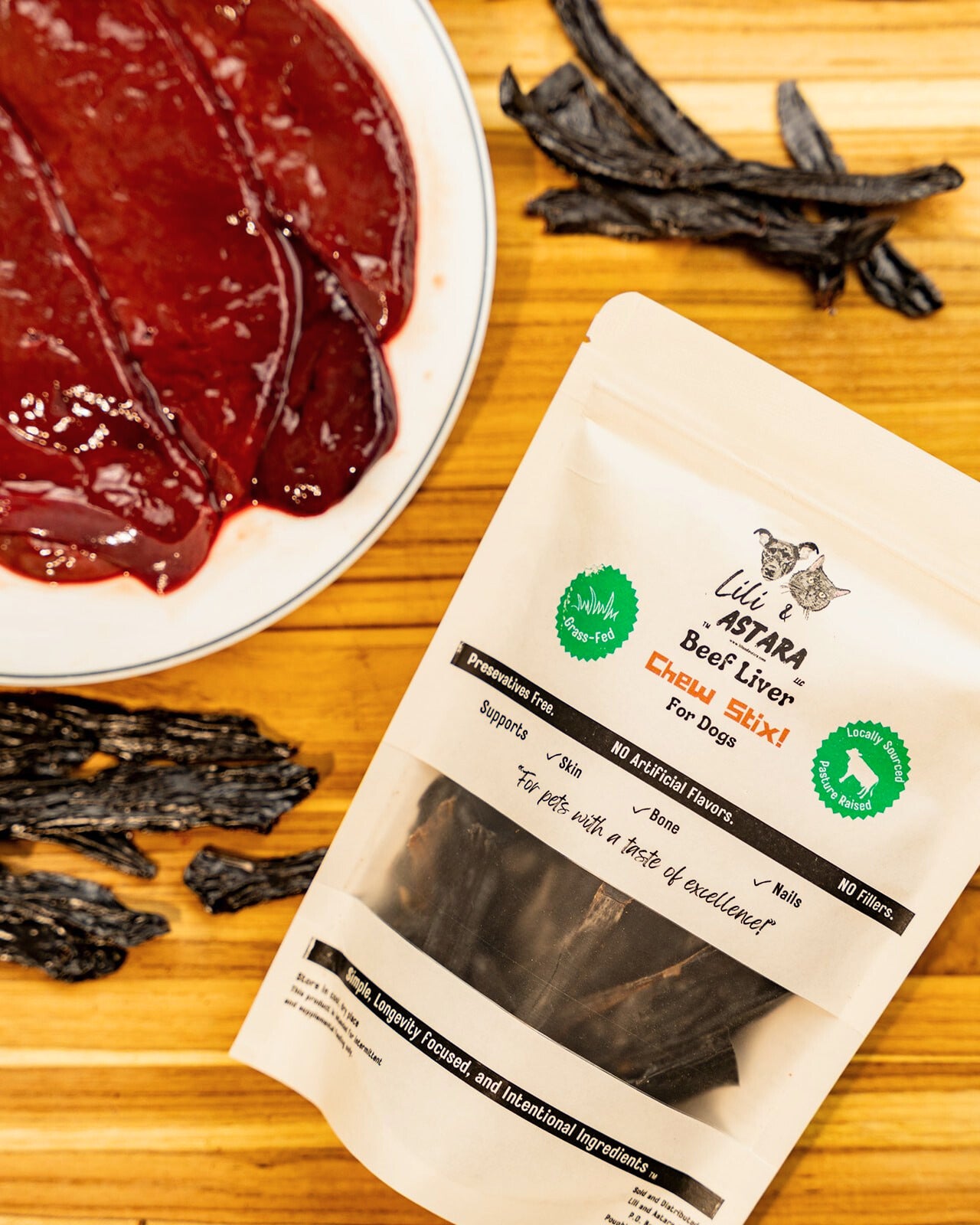 Lili Astana Beef Liver Chew Large package on a wooden surface with dried beef liver pieces.